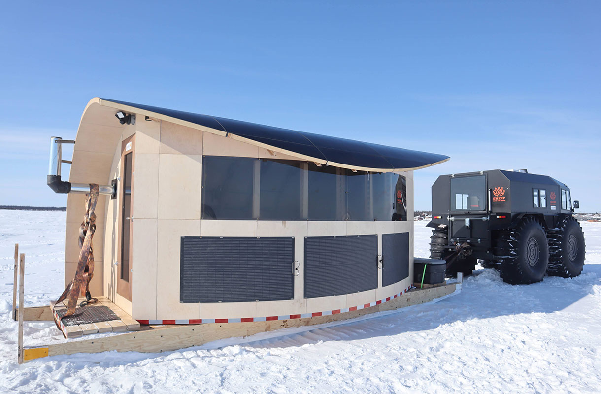 Portable research lab being towed by SHERP vehicle on frozen lake